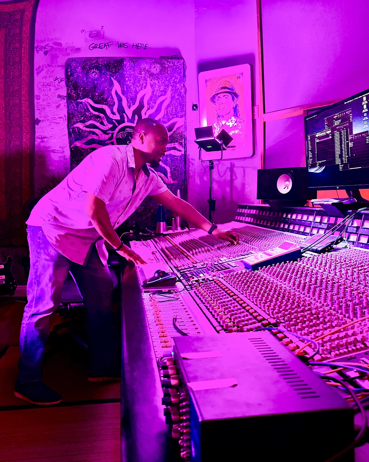 Samori Coles working a mixing console in the studio